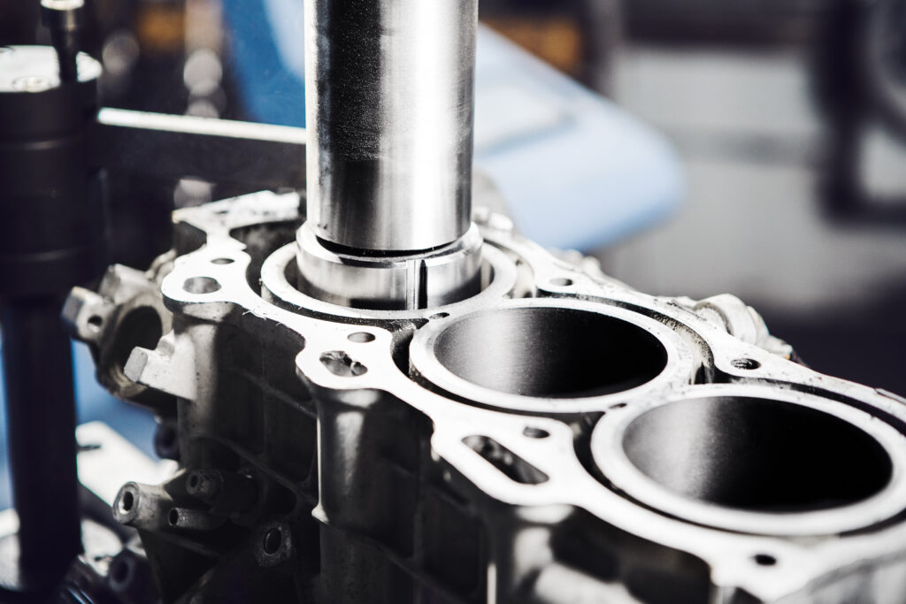 Car engine cylinder head on CNC machine during service boring piston for increase power